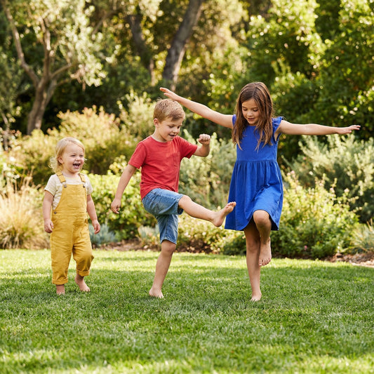Kids playing actively outdoors in summer without screens